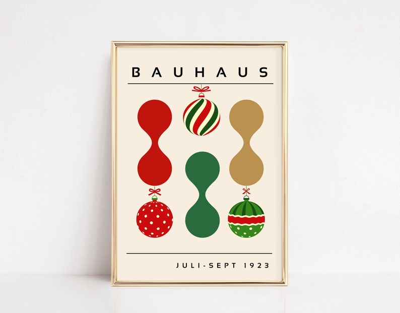 May include: A framed poster with a cream background featuring the text BAUHAUS at the top and JULI-SEPT 1923 at the bottom. The design includes three vertical columns of abstract shapes and Christmas ornaments in red, green, and gold colors.