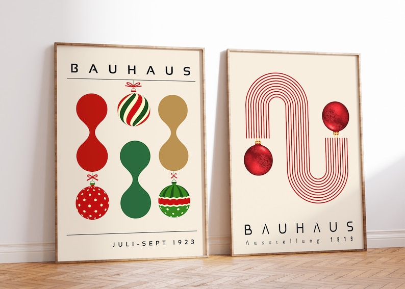 May include: Two framed posters with cream backgrounds. The left poster features the text BAUHAUS, JULI-SEPT 1923, and colorful ornaments. The right poster displays BAUHAUS, Ausstellung 1919, red line patterns, and two red spherical ornaments.