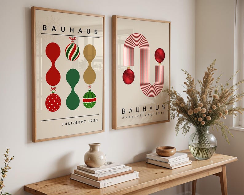 May include: Two framed wall art prints featuring Bauhaus exhibition posters. The left print displays abstract shapes and Christmas ornaments with the text BAUHAUS and JULI-SEPT 1923. The right print shows red line arches and ornaments with the text BAUHAUS Ausstellung 1923.