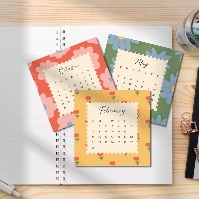 May include: Three square calendar cards featuring floral patterns in red, green, and yellow. Each card displays a month, October, May, or February, with its corresponding grid of dates. The cards have scalloped edges and are arranged in a stack.