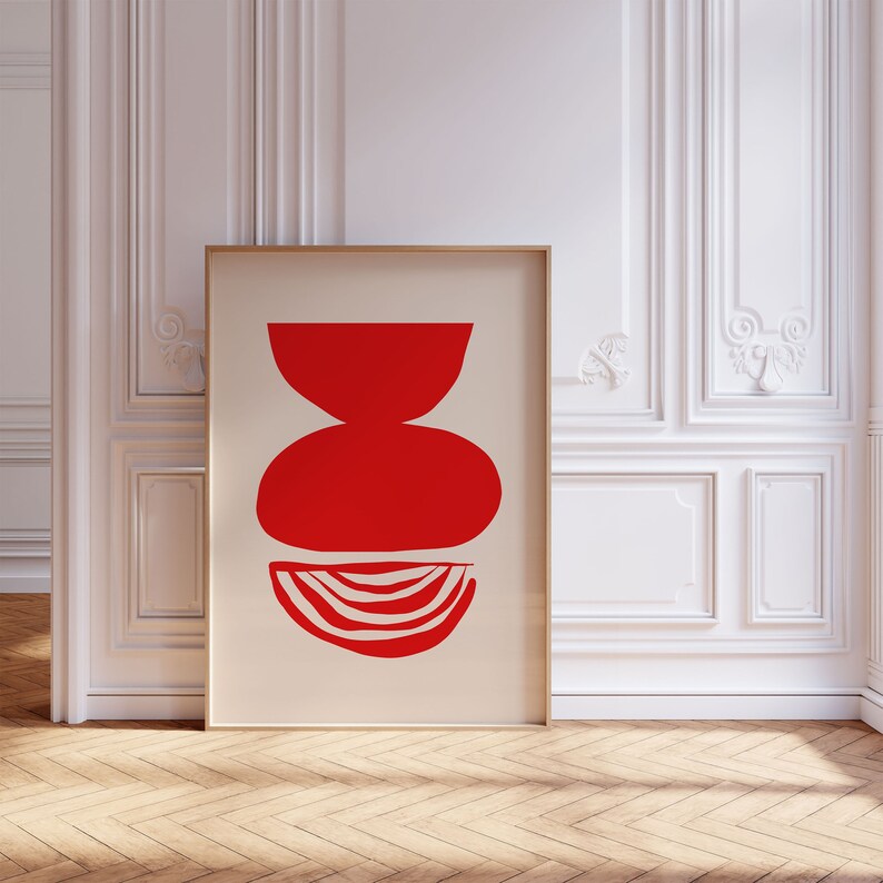 May include: Abstract art print featuring three red geometric shapes on a cream background. The shapes are a bowl, a circle, and a crescent moon.