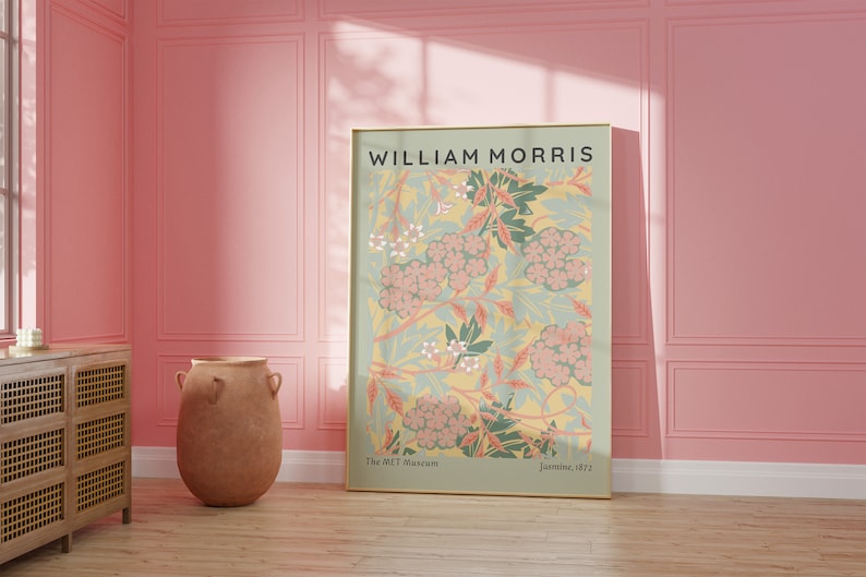 May include: A framed poster with a floral design in shades of pink, green, and yellow. The poster features the text "WILLIAM MORRIS" at the top and "The MET Museum" and "Jasmine, 1872" at the bottom.