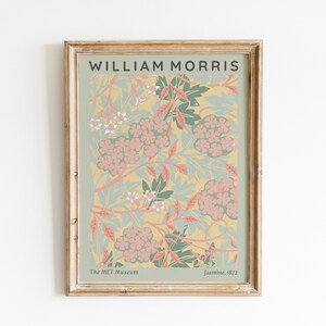 May include: A framed print of a floral pattern by William Morris, titled "Jasmine, 1872". The print features a yellow background with pink and green flowers and leaves. The print is from The Met Museum.