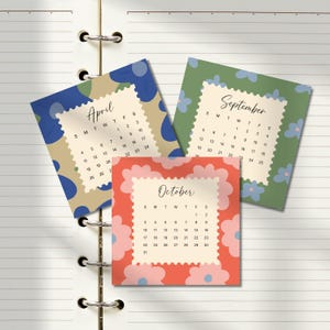 May include: Three square calendar cards for April, September, and October. The April card has a blue and tan abstract pattern, the September card features a green floral design, and the October card displays a red and pink flower motif.
