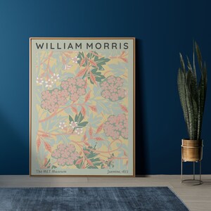 May include: A framed print of a floral pattern by William Morris, titled "Jasmine, 1872". The print features a yellow background with pink and green flowers and leaves. The text "The MET Museum" is at the bottom left corner of the print.