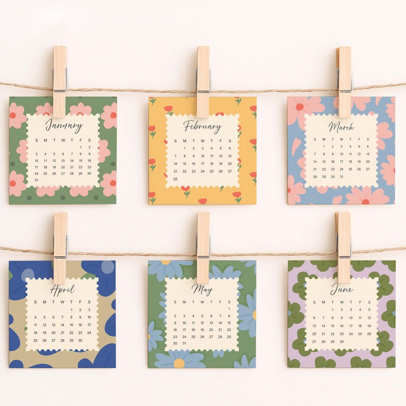 May include: Six square calendar cards for January through June, each featuring a unique floral pattern and scalloped edges. The cards are held by wooden clothespins on a string. Each card displays the month name and a grid of dates.