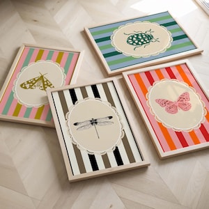 May include: Four framed prints with a striped background and a white lace oval containing a different insect or butterfly in each. The insects are a moth, a ladybug, a butterfly, and a dragonfly.