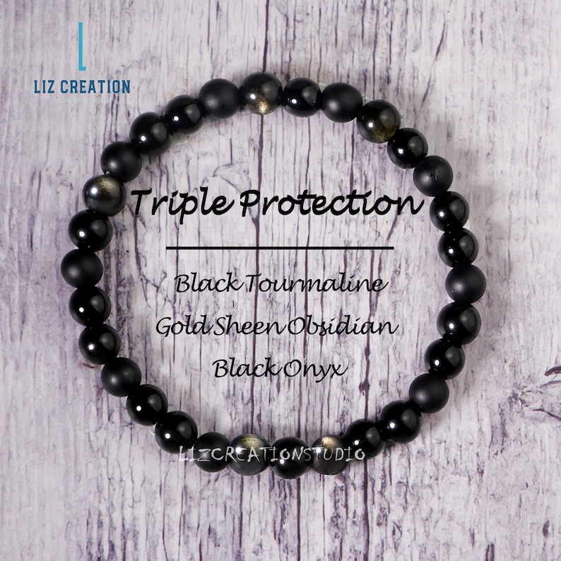 May include: A black beaded bracelet with the text "Triple Protection" and the words "Black Tourmaline, Gold Sheen Obsidian, Black Onyx". The bracelet is made of round, polished beads.