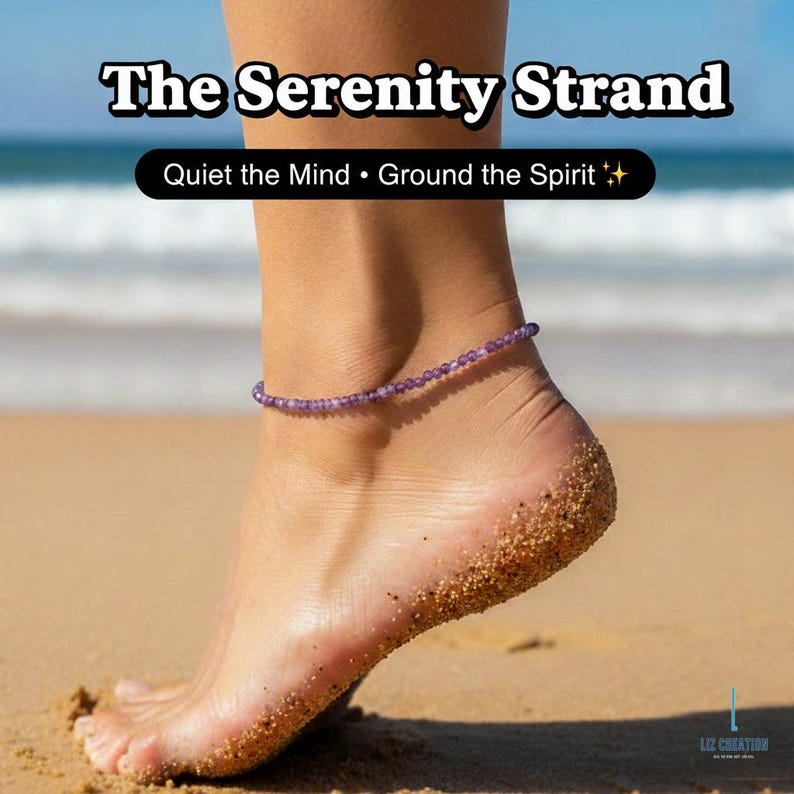 May include: A purple beaded anklet, "The Serenity Strand," adorns an ankle on a sandy beach. The text "Quiet the Mind &bull; Ground the Spirit" is above the ankle. The image is a close-up of a foot with sand on the skin.
