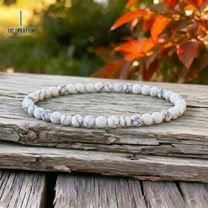 May include: A white ceramic mug with a black handle and the text "But First, Coffee" in a bold, black font. The mug is set against a neutral background, highlighting its simple design.