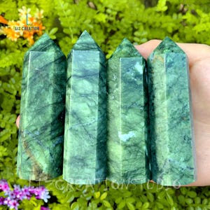 May include: Four green serpentine crystal points, each with a unique pattern of veining. The crystals are polished and have a smooth, glassy finish.