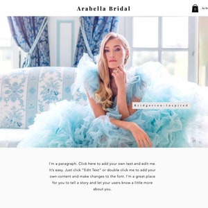 May include: A woman in a light blue tulle gown poses on a couch. The gown has a ruffled skirt and a sweetheart neckline. The text "Bridgerton-Inspired" is visible in the image.