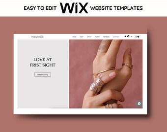 May include: A website template design with the text "EASY TO EDIT Wix WEBSITE TEMPLATES". The website design features the text "LOVE AT FRIST SIGHT" and "Start Shopping". The image also shows a hand wearing multiple rings and bracelets.