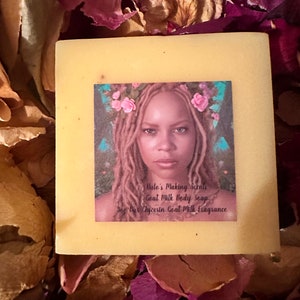 May include: A yellow bar of goat milk body soap with a floral design and the text "Halo's Making Scents Goat Milk Body Soap 5oz Glycerin Goat Milk Fragrance".