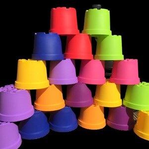 May include: A stack of colourful plastic pots arranged in a pyramid shape. The pots are in various colours, including red, green, yellow, blue, purple, and orange.