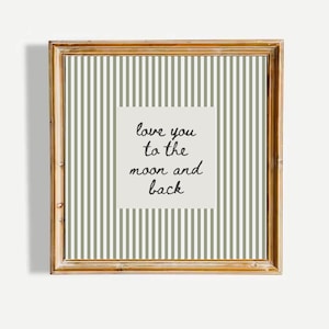 May include: A framed print with a gold-colored wooden frame. The print features a background of vertical olive green and white stripes. A square in the center has the handwritten text, "love you to the moon and back."