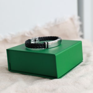 LEATHER and  STEEL BRACELET. Black braided leather and Stainless Steel Bracelet. Clasp Closure. Inner Diameter-2.7 inch (7cm). Comes in Box.