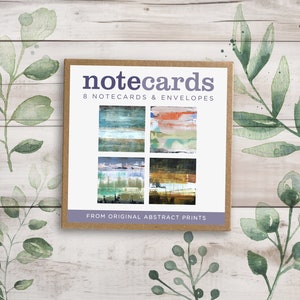 May include: A box of 8 notecards and envelopes featuring abstract art prints. The box is brown with white text that reads "notecards 8 notecards & envelopes from original abstract prints".