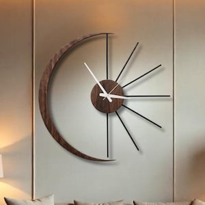 Statement moon wall clock with crescent wood and metal sunburst design in modern living room decor