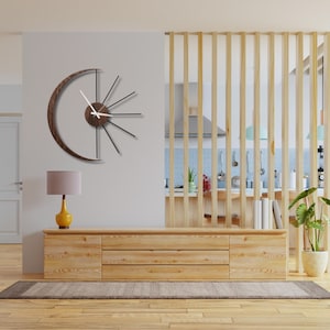 Precision cut metal rays and solid wood crescent detail of large moon wall clock