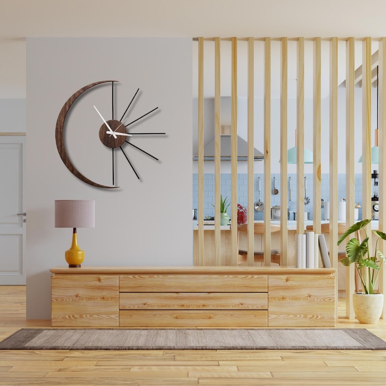 Precision cut metal rays and solid wood crescent detail of large moon wall clock