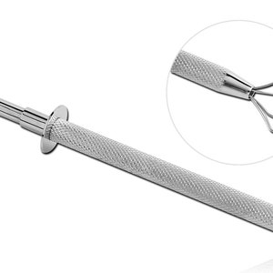 May include: A silver metal tool with a long, textured handle and a five-pronged claw at the end.