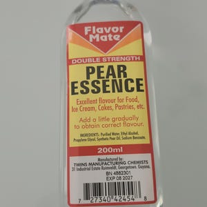 May include: A clear glass bottle of "Flavor Mate" Pear Essence, a food flavoring. The label is yellow and red with black text, including "Double Strength" and "200ml". The bottle has a white cap.