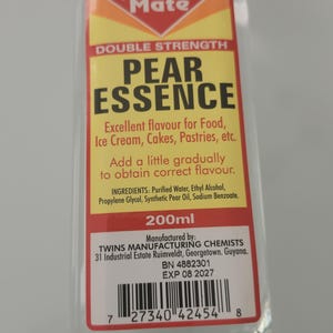 May include: A clear glass bottle of Flavor Mate Pear Essence. The label is yellow, red, and white, with text indicating it's double strength and for food flavoring. Contains 200ml.