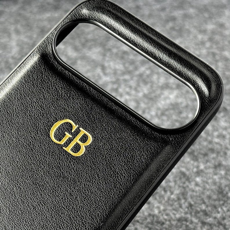 May include: Black leather phone case with a gold embossed "GB" monogram.