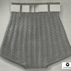May include: Gray knitted shorts with a white belt and silver buckle. The shorts have a cable knit pattern.