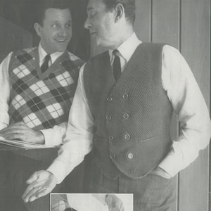 May include: Two men wearing vests, one with a plaid pattern and the other with a solid pattern. The man on the right is adjusting his vest and has his hand in his pocket. The man on the left is holding a piece of paper. The image also shows a close-up of a person's foot wearing a black shoe and a patterned sock.