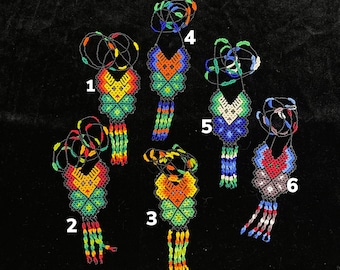 May include: Six colorful beaded necklaces with fringe, each with a different pattern and color combination. The necklaces are numbered 1 through 6.