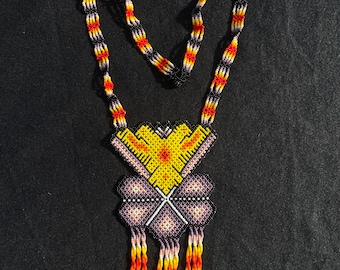 May include: A beaded necklace with a geometric pattern in shades of yellow, orange, purple, and black. The necklace has a long, fringed pendant.