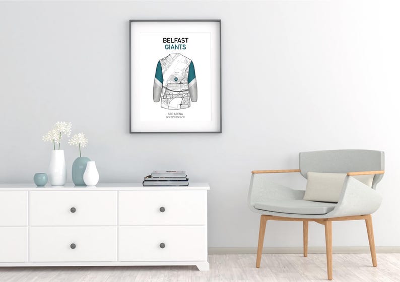 May include: Framed art print featuring a detailed illustration of a hockey jersey, with the text "Belfast Giants" at the top. The jersey design incorporates teal accents. Below the jersey is the text "SSE Arena, Belfast".