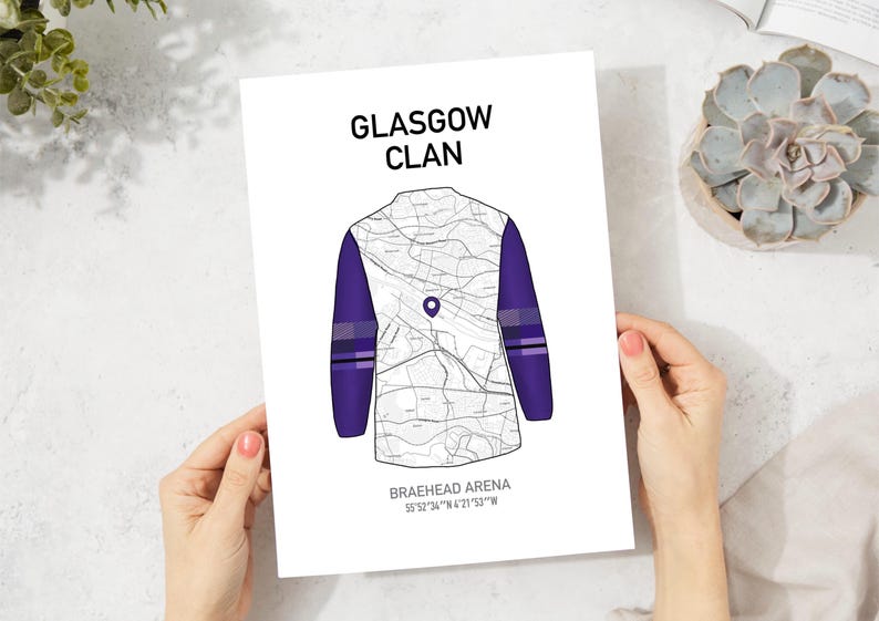 May include: A white print featuring a map design in the shape of a jersey, with purple sleeves and accents. The text "GLASGOW CLAN" is at the top, and "BRAEHEAD ARENA" with coordinates are at the bottom.