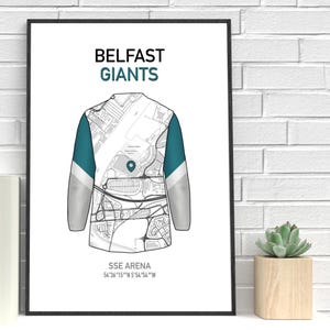 May include: A framed print featuring a jersey design with a map overlay. The words "BELFAST GIANTS" are at the top, with "SSE ARENA" and coordinates at the bottom. The jersey has teal and gray accents.