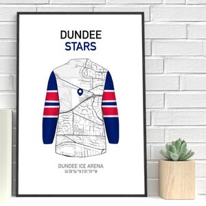 May include: A framed print featuring a stylized hockey jersey design. The jersey is white with blue sleeves and red stripes. The jersey design incorporates a map of the city. The text "DUNDEE STARS" is at the top.