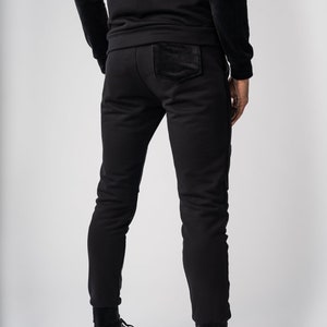 May include: Black sweatpants with a velvet patch on the back pocket.