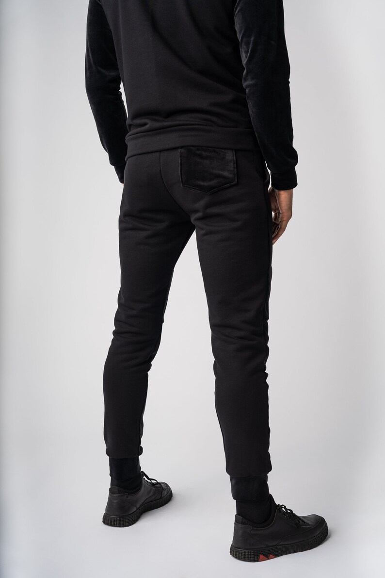 May include: Black sweatpants with a velvet patch on the back pocket.