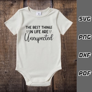 May include: White baby onesie with black text that reads "The best things in life are unexpected" with two small hearts on either side of the word "are".