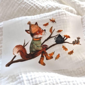 May include: A fox wearing a green and white sweater and a brown hat sits on a branch with a cup of tea. A black teapot and a bird are on the branch. There are brown leaves scattered around the branch.