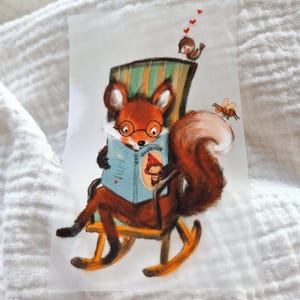 May include: A red fox wearing glasses sits in a rocking chair and reads a book. A small bird with red hearts above it sits on the back of the chair. A bee flies near the fox's tail.