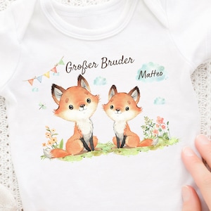 May include: White baby bodysuit with a fox illustration and the text "Großer Bruder Matteo".
