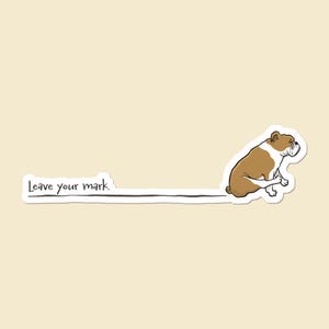 May include: A cartoon illustration of a brown and white bulldog sitting down, leaving a black line. The text "Leave your mark" is written in black, following the line. The background is a light beige color.