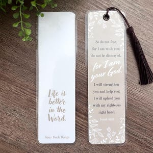 May include: Two white bookmarks with inspirational quotes and floral designs. The left bookmark says "Life is better in the Word." The right bookmark says "So do not fear, for I am with you; do not be dismayed, for I am your God. I will strengthen you and help you; I will uphold you with my righteous right hand. Isaiah 41:10."