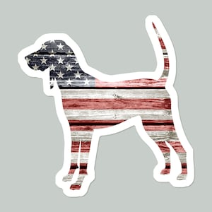 May include: Silhouette of a dog in the shape of the American flag. The flag is made of wood planks with a distressed look. The stars are blue and the stripes are red and white.