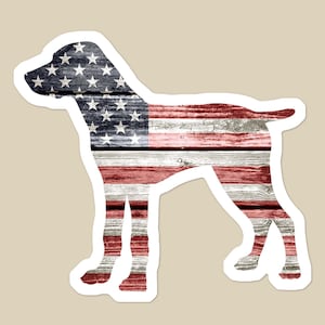 May include: Silhouette of a dog with the American flag design on a wood grain background.