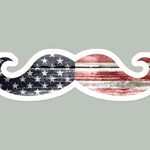 May include: A white sticker with a red, white, and blue American flag design in the shape of a mustache.