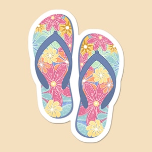 May include: A pair of blue flip-flops with a floral pattern in shades of pink, yellow, and green.