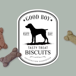 May include: White sticker with a black silhouette of a dog and the text "Good Boy", "Ruff Day", "Tasty Treat Biscuits", and "Satisfaction Guaranteed".